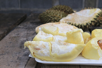 Durian riped and fresh with yellow colour on wooden table.