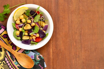 Eggplant Salad with Chickpeas and Fresh Vegetables, top view, copy space