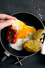 Fried egg in a frying pan with bread