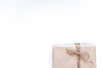 Eco gift box wrapping in kraft paper on white background isolated. Vintage eco-friendly natural style. Top view composition,New year holiday flatlay,copy space