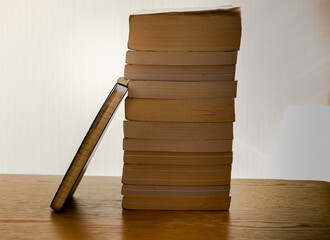 Stack of books and notebook on a wooden table