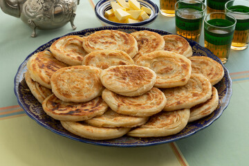 Fresh baked meloui, Moroccan pancakes, butter and tea