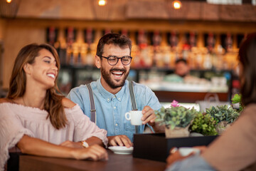 Lovely couple have fun together in cafe.