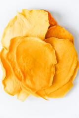 Mango chips on a white background. Dried and fresh mango on a white background.