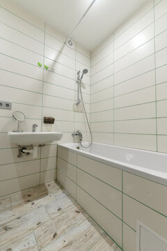 bathroom, toilet, sink, bathtub, white, light with white tiles