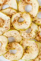 Chips from apples with cinnamon on a white background. Dried and fresh apples on a white background.