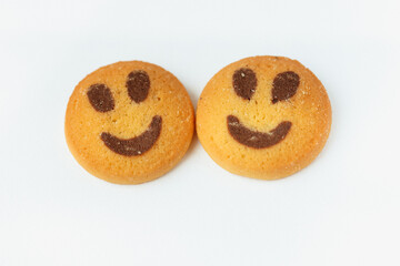 Two smiling biscuit cookies isolated on white background with copy space. Smile concept. Sweet  friendship and greeting