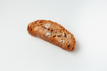 Popular Italian Biscotti or Cantucci biscuit cookie stuffed with nuts isolated on white background with copy space.Side view closeup