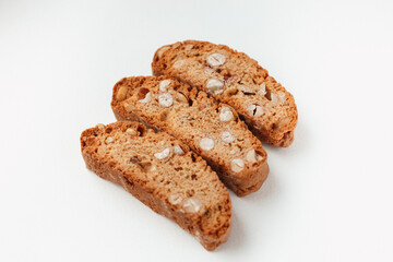 Three famous Italian Biscotti or Cantucci cookies stuffed with nuts  isolated on white background.