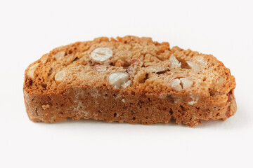 Popular Italian Biscotti or Cantucci biscuit cookie stuffed with nuts isolated on white background with copy space.Side view closeup