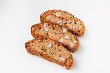 Three famous Italian Biscotti or Cantucci cookies stuffed with nuts  isolated on white background.
