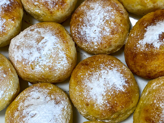 Homemade buns sprinkled with powdered sugar