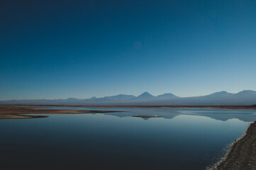 Quietly situated sea with a view of distant mountains on the horizon