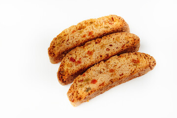 Three famous Italian Biscotti or Cantucci cookies stuffed with candied fruit isolated on white background.