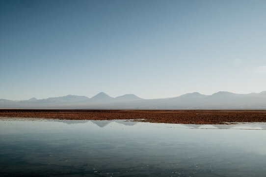 Quietly situated sea with a view of distant mountains on the horizon
