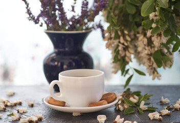 Cup of coffeel and acacia closeup. Nutrition. background with a cup of Coffee and acacia flowers.