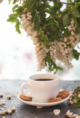 Cup of coffeel and acacia closeup. Nutrition. background with a cup of Coffee and acacia flowers.