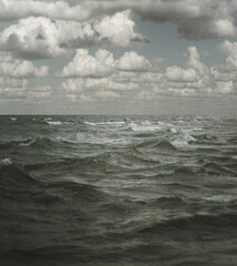 White fluffy clouds over the sea or ocean summer background