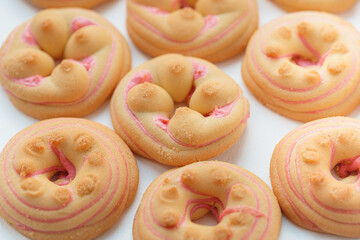 Cookie biscuit with pink  sugar cream icing  isolated on white background