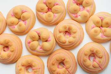 Cookie biscuit with pink  sugar cream icing  isolated on white background