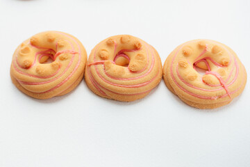 Cookie biscuit with pink  sugar cream icing  isolated on white background