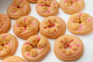 Cookie biscuit with pink  sugar cream icing  isolated on white background