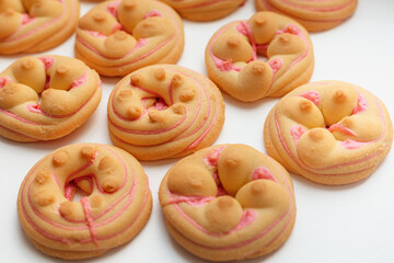 Cookie biscuit with pink  sugar cream icing  isolated on white background