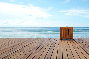 Fototapeta na wymiar Wooden platform beside sea with clear sky - Stock image