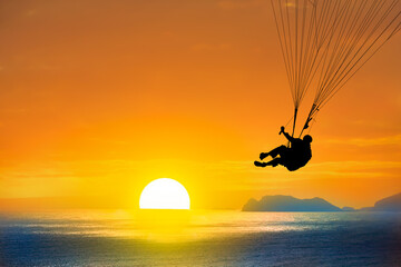 paraglider silhouette at sunset