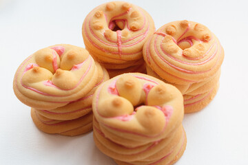 Cookie biscuit with pink  sugar cream icing  isolated on white background