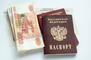 Passports of Russian citizen and ruble banknotes in cash are on train tickets