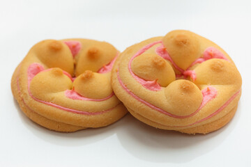 Cookie biscuit with pink  sugar cream icing  isolated on white background