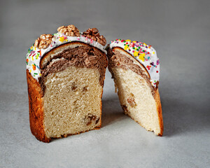 Sweet marbled bread on a gray background. Glazed bread and walnuts