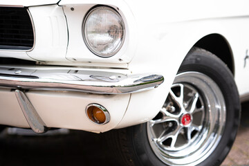 Side view with headlight and chrome bumper of classic american mussle car