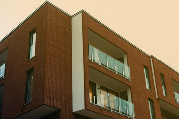 Part of a brick building with modern architecture in the evening