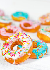 Colorful Donuts turquoise and pink on White Background close-up. Doughnuts with multi colored glaze. Doughnuts are traditional sweet pastries. beautiful and bright pastries