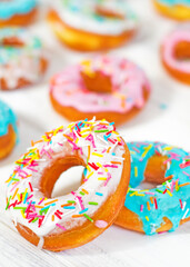 Colorful Donuts turquoise and pink on White Background close-up. Doughnuts with multi colored glaze. Doughnuts are traditional sweet pastries. beautiful and bright pastries