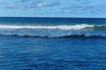 Beautiful strong sea waves under blue sky