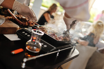 the chef holds a master class for cooking meat for the guests of the restaurant