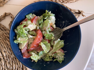 Rose Tomato salad greens and yogurt with spoon