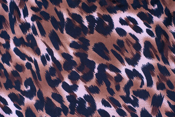 A picture of the wool of the leopard on the fabric. Close up leopard spot pattern texture background