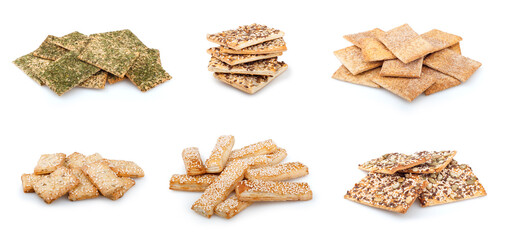 Collection of crackers on a white background. Layered dough with sesame and seasonings. Crispy cookies with various additives. Crackers with sunflower seeds and pumpkin seeds.