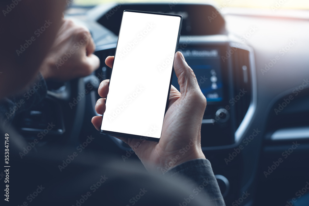 Wall mural Mockup image of man driver using blank mobile smart phone inside  a car