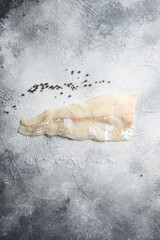 Cod fillets on a grey concrete background for the preparation of a healthy dish top view space for text