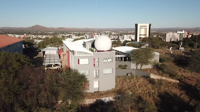 4K aerial drone video savanna hills, Windhoek meteorological service viewpoint, Windhoek high school sport grounds in city center in Namibia's capital in central highland Khomas Hochland of Namibia, s