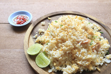 Fried rice with egg on wooden table.