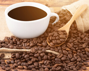 Closeup coffee cup and coffee beans on wooden background with the coffee sack and morning sunlight, black coffee in the morning concept
