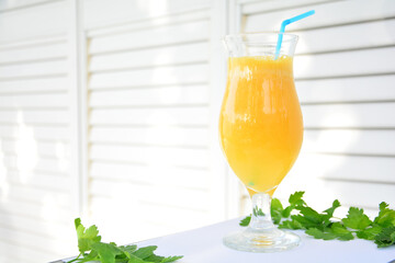 Green parsley and  orange in slices on a white