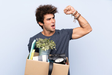 Man making a move while picking up a box full of things celebrating a victory