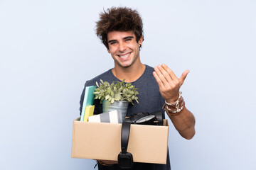 Man making a move while picking up a box full of things inviting to come